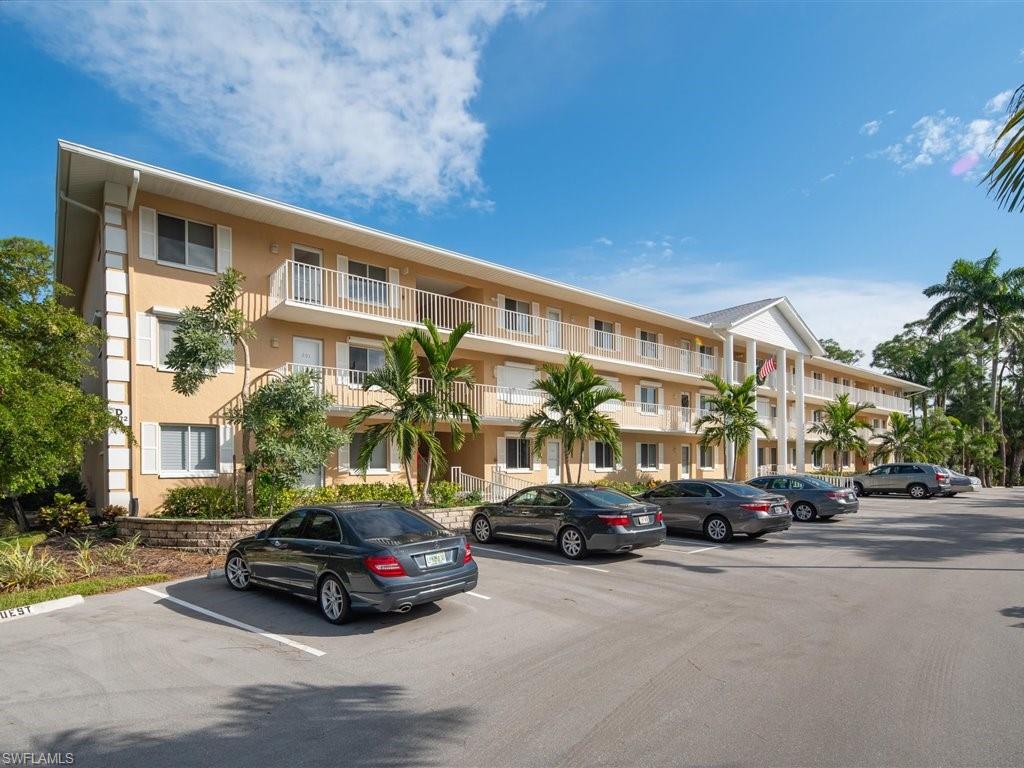 3012 Sandpiper Bay Circle, Unit D301 Naples, FL 34112 - Photo 18 of 23 a car parked in front of a building