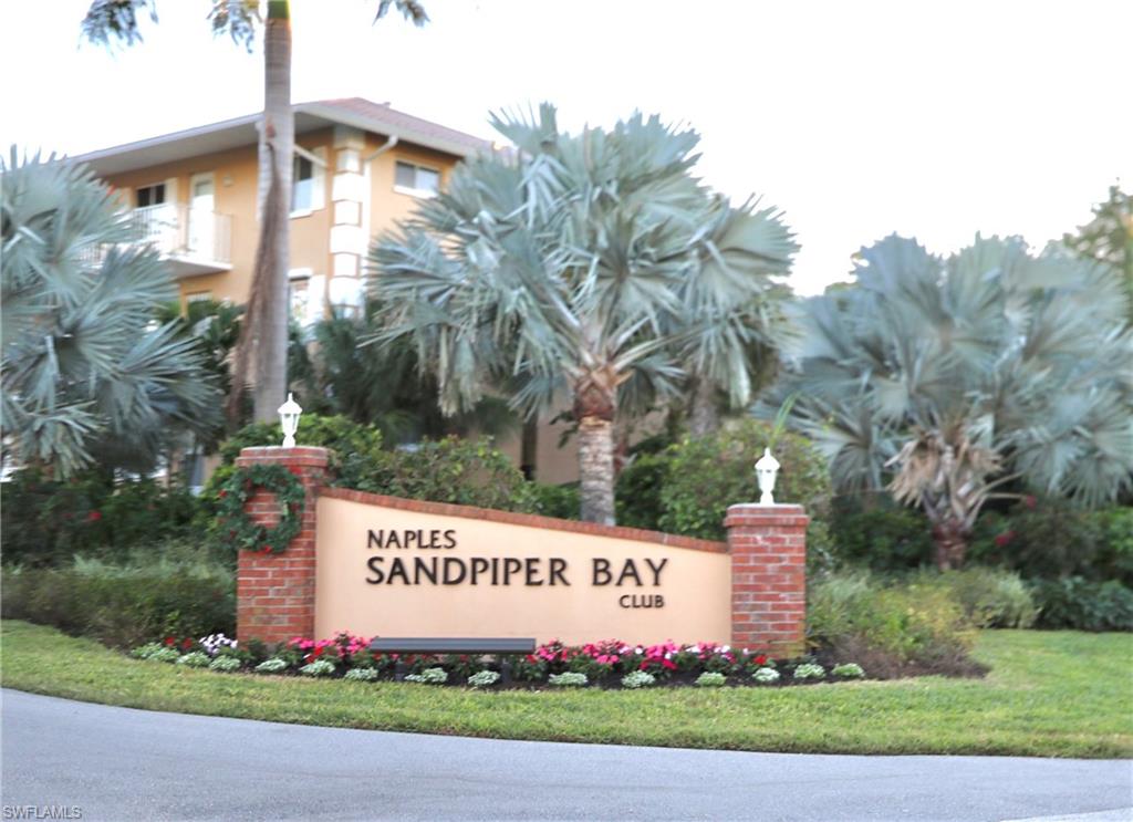 3012 Sandpiper Bay Circle, Unit D301 Naples, FL 34112 - Photo 19 of 23 a sign on the side of a road