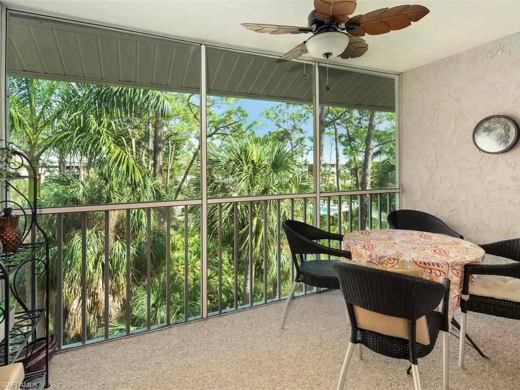3012 Sandpiper Bay Circle, Unit D301 Naples, FL 34112 - Photo 6 of 23 a view of a patio with table and chairs