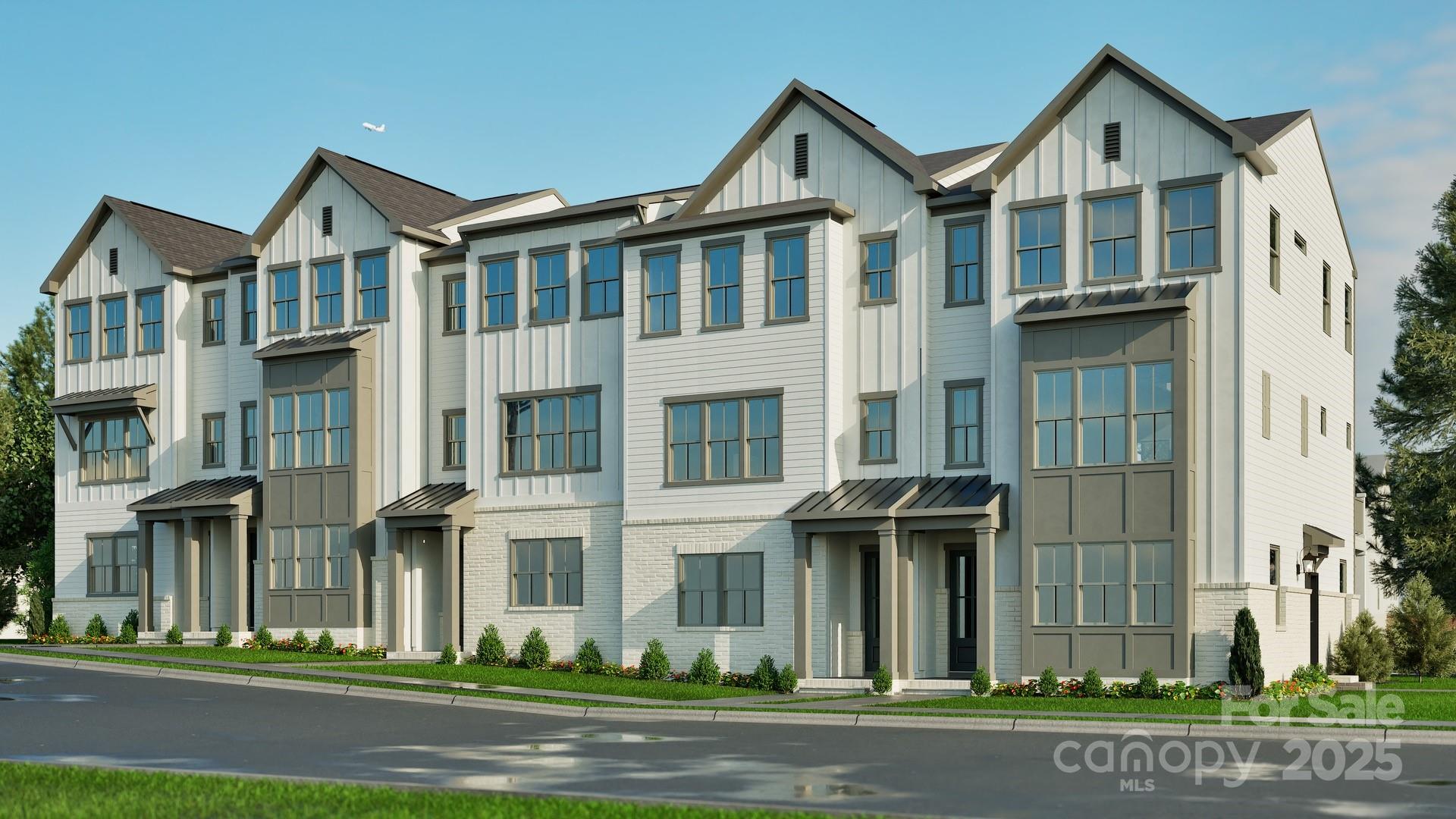 a front view of a residential apartment building with a yard