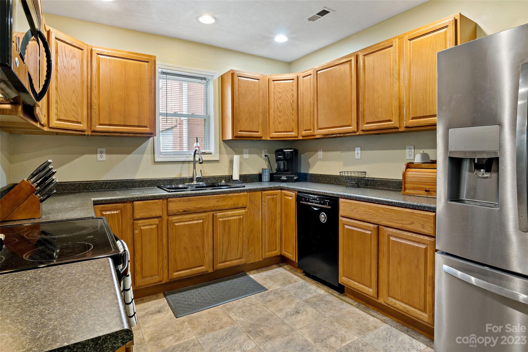 134 Spring Street Old Fort, NC 28762 - Photo 16 of 34 a kitchen with stainless steel appliances granite countertop a refrigerator sink and stove