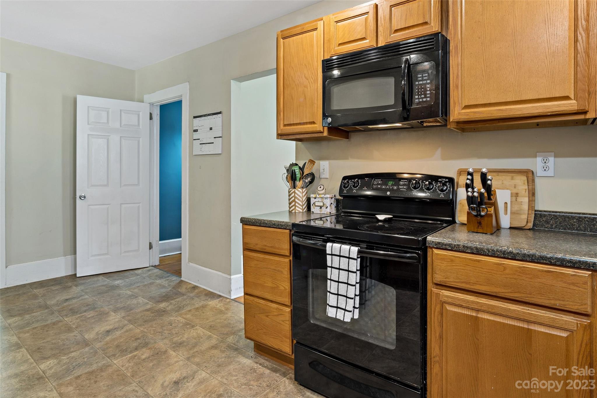 134 Spring Street Old Fort, NC 28762 - Photo 19 of 34 a kitchen with stainless steel appliances granite countertop a stove and a microwave