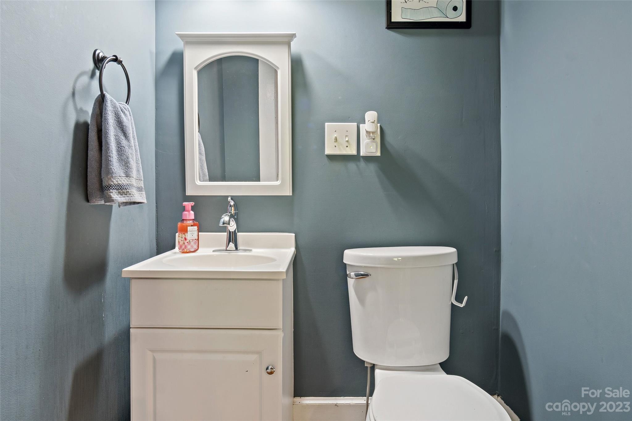 134 Spring Street Old Fort, NC 28762 - Photo 20 of 34 a bathroom with a toilet sink and mirror