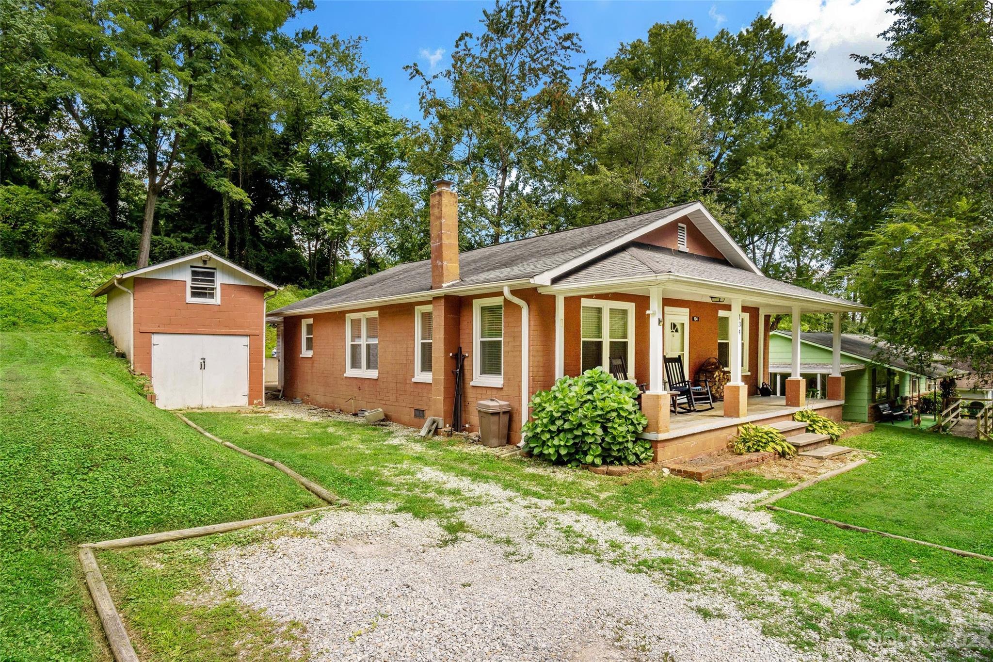 134 Spring Street Old Fort, NC 28762 - Photo 2 of 34 a front view of a house with garden