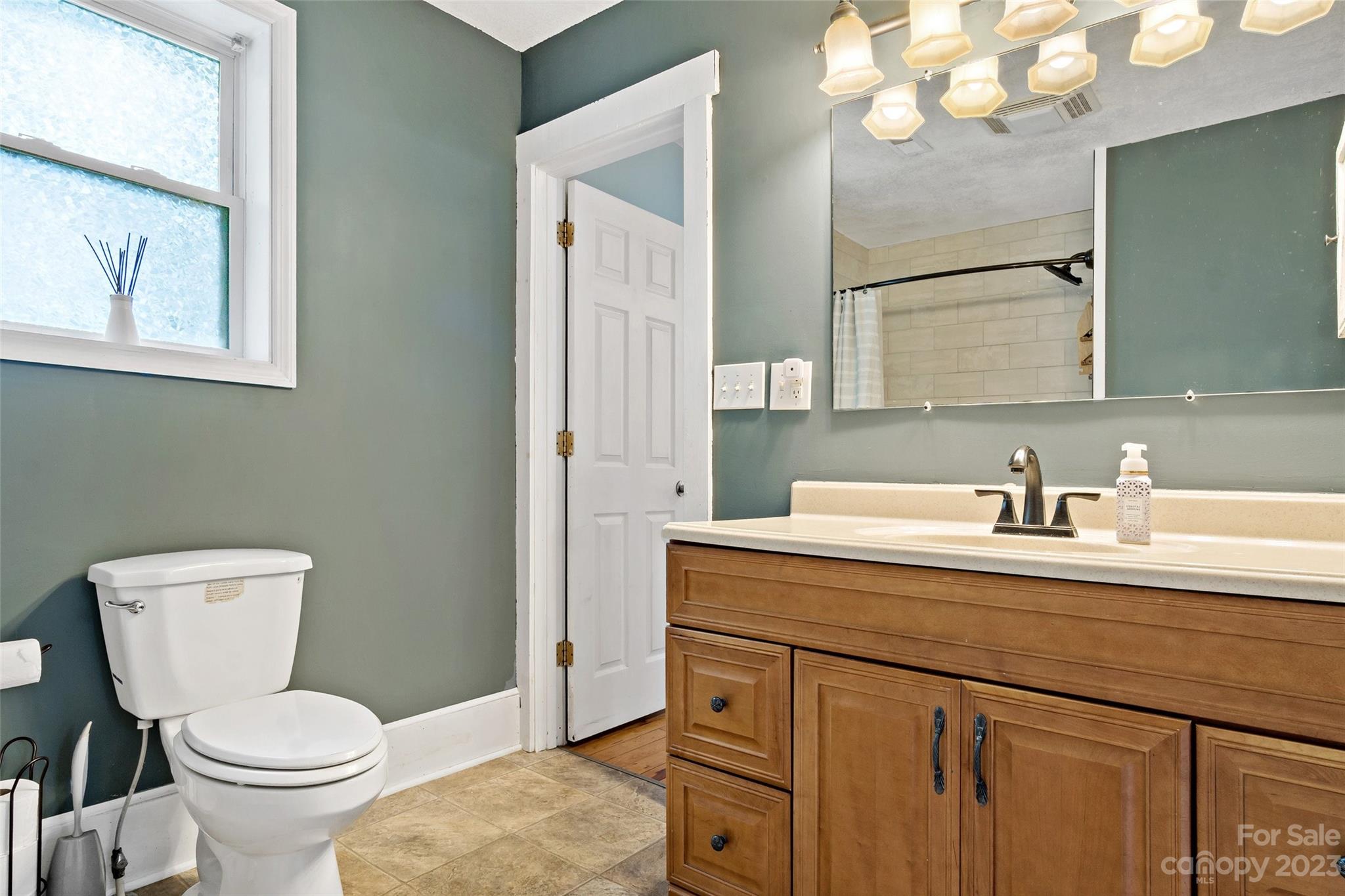 134 Spring Street Old Fort, NC 28762 - Photo 25 of 34 a bathroom with a toilet sink and mirror