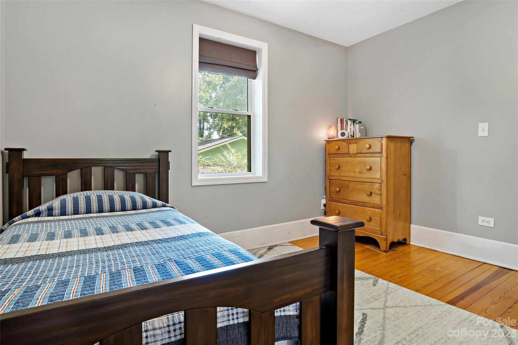 134 Spring Street Old Fort, NC 28762 - Photo 28 of 34 a bedroom with a bed and a window