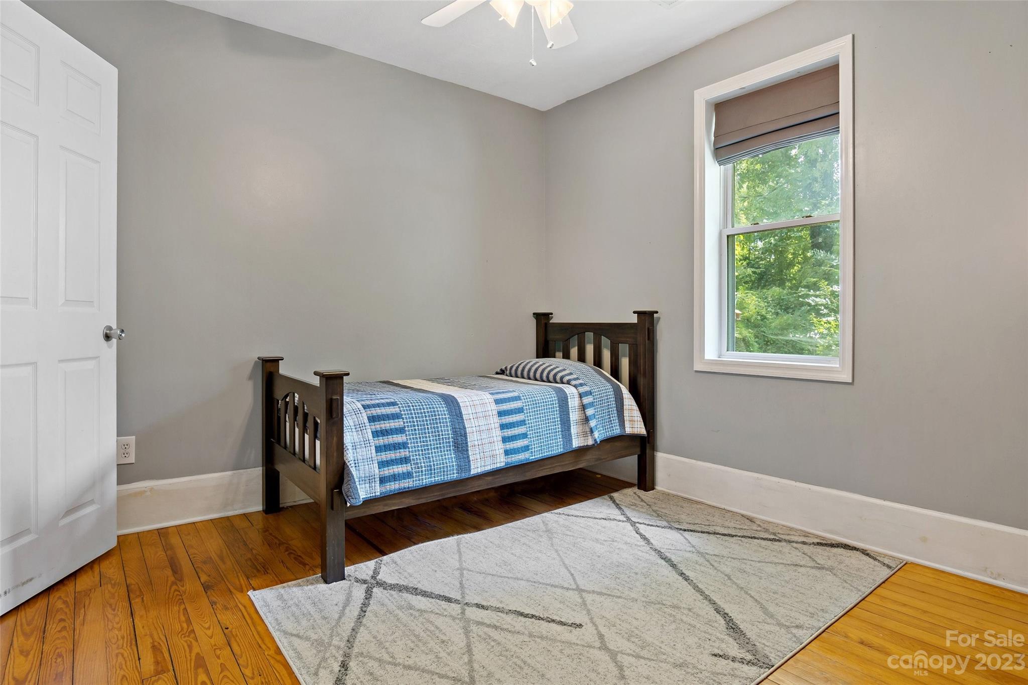 134 Spring Street Old Fort, NC 28762 - Photo 29 of 34 a bedroom with a bed and a window