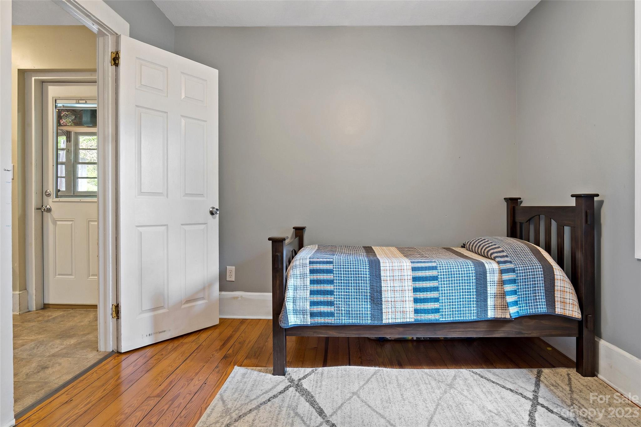 134 Spring Street Old Fort, NC 28762 - Photo 30 of 34 a bedroom with a bed and wooden floor