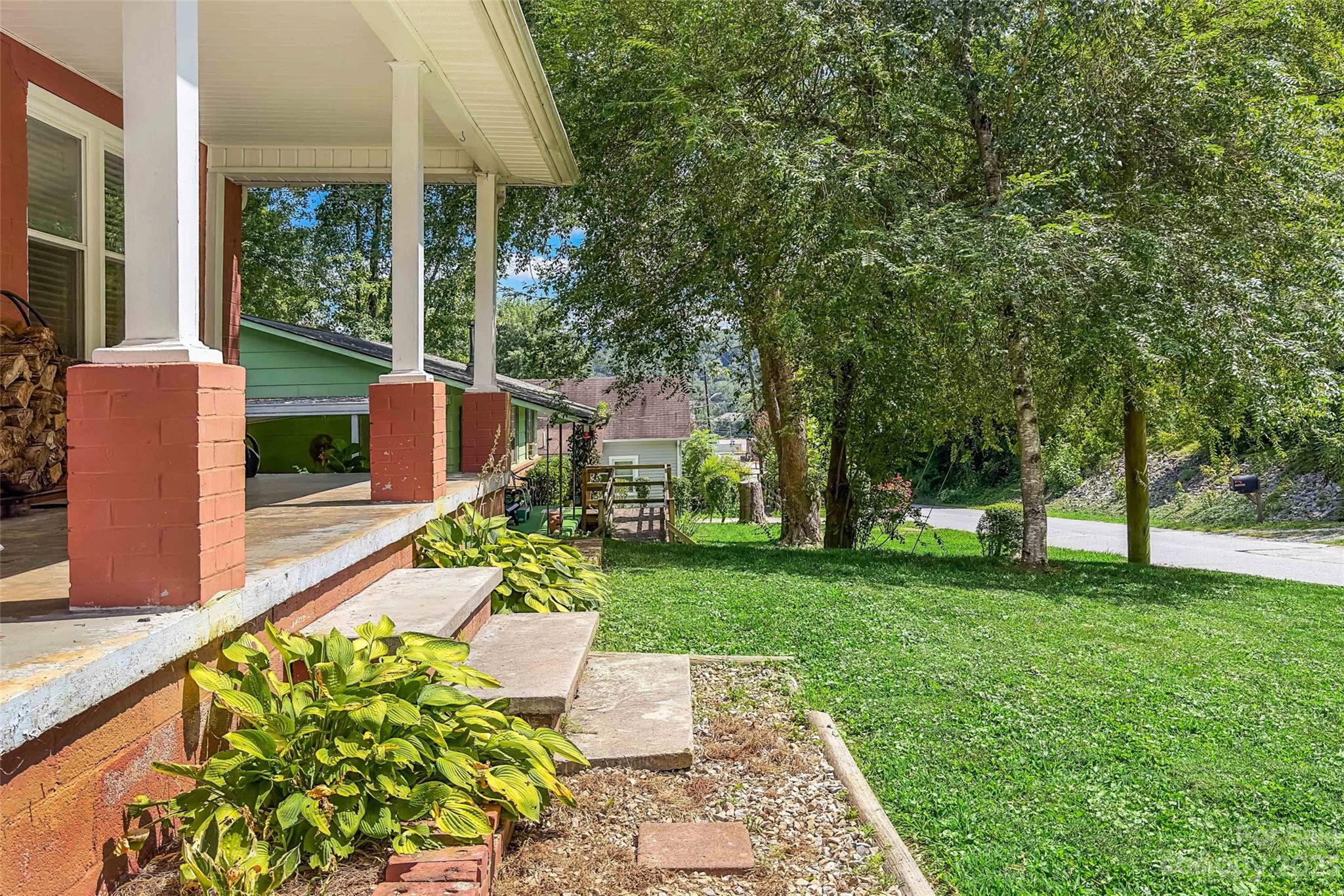 134 Spring Street Old Fort, NC 28762 - Photo 5 of 34 a garden view with a seating space