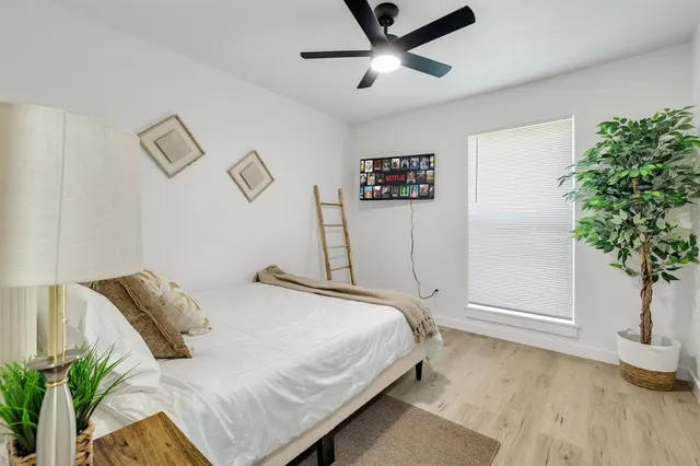 a bedroom with a bed and a potted plant