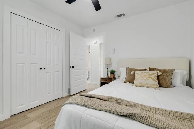 a bedroom with a bed and wooden floor