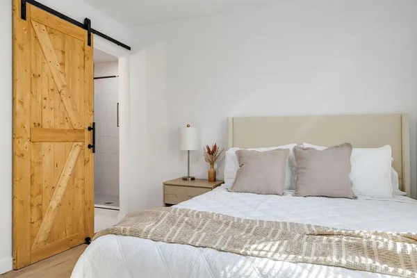 a bedroom with a bed and a mirror