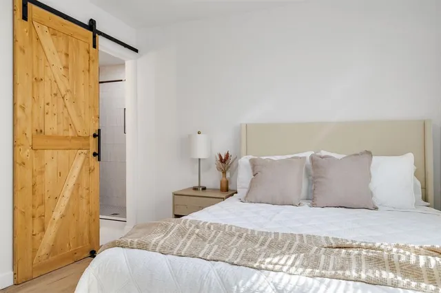 a bedroom with a bed and a mirror