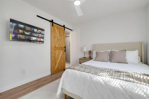 a bedroom with a bed and a wall painting