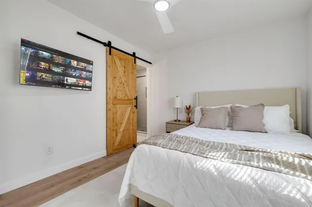 a bedroom with a bed and a wall painting