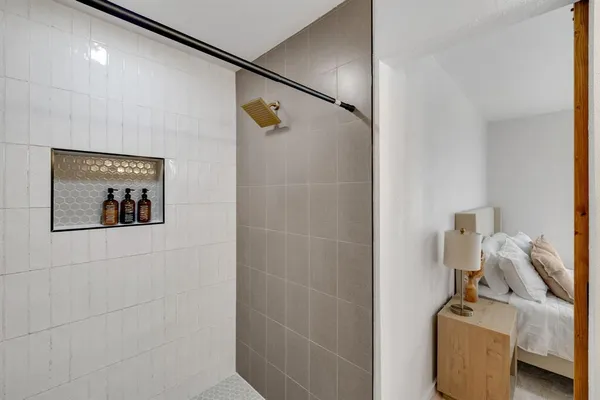 a bathroom with a window and a shower