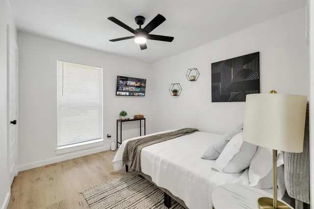 a bedroom with a bed and a lamp on table