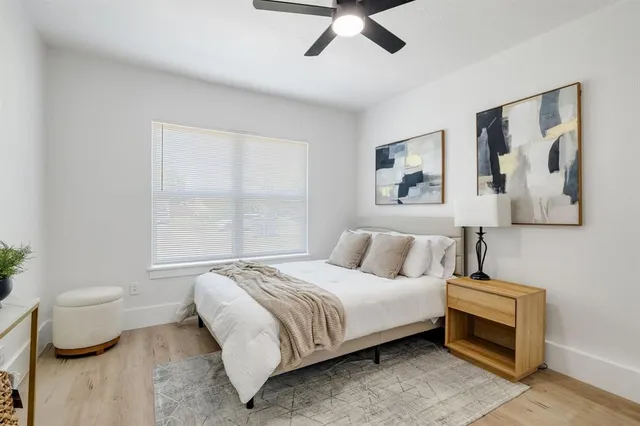 a bedroom with a bed and a painting on the wall