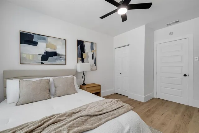 a bedroom with a bed and a painting on the wall