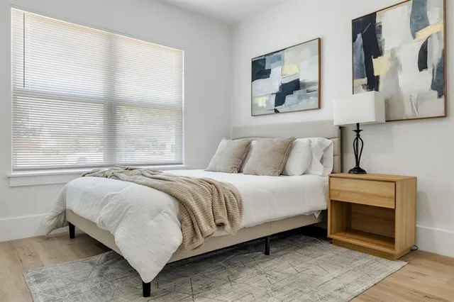 a bedroom with a bed and a window