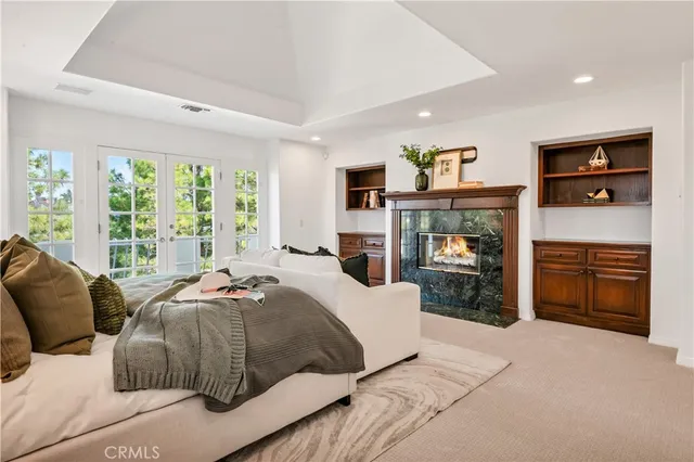 a spacious bedroom with a bed and a cabinets
