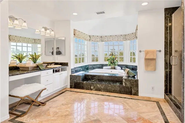 a large white kitchen with a large window and stainless steel appliances