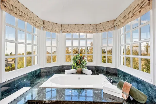 a view of a dining room with furniture large windows and wooden floor