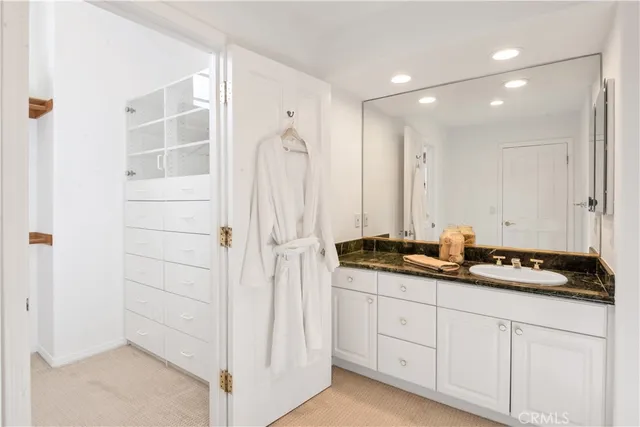 a bathroom with double sink and a mirror