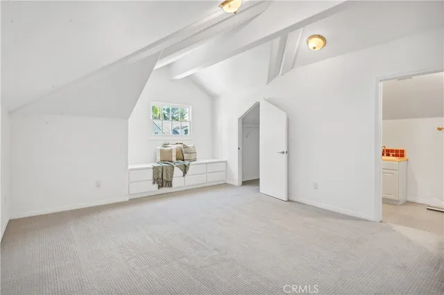 a spacious bedroom with a bed and a large window