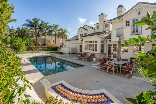 a patio with yard glass top table and chairs
