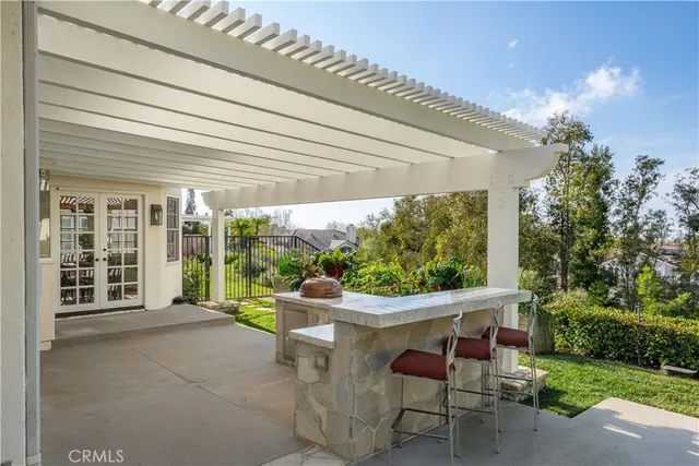 a view of a porch with furniture and garden