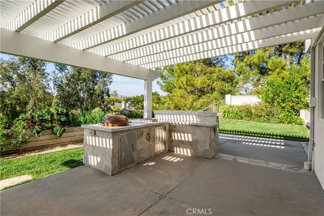 a view of a chairs and table in backyard of the house