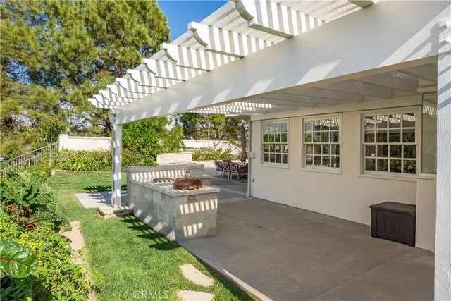 a view of a house with a yard and potted plants