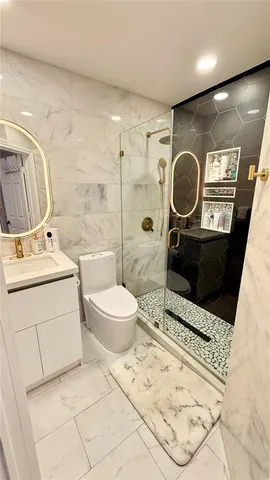 a bathroom with a toilet a sink and mirror