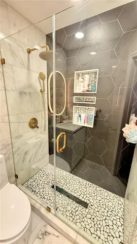 a bathroom with a sink toilet and shower