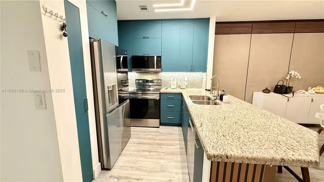 a kitchen with a table chairs refrigerator and a sink