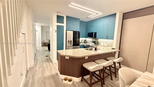 a kitchen with a stove sink and a refrigerator