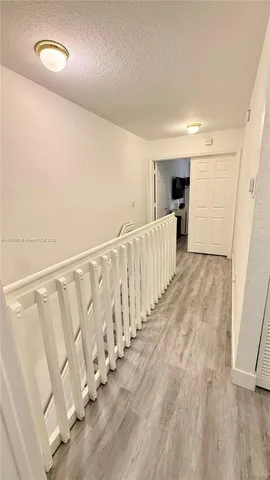 a living room with a bed furniture and a night stand