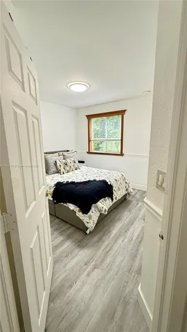 a bed sitting in a bedroom next to a window