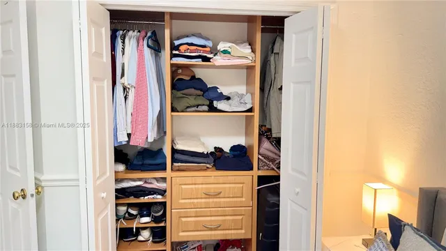 a view of a hallway with wooden floor and entryway
