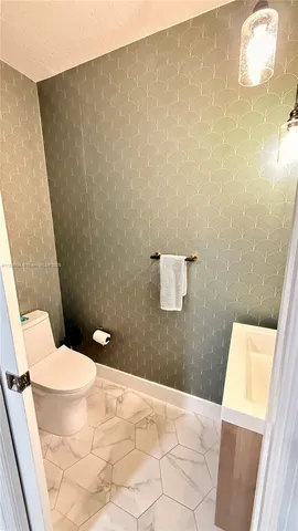 a bathroom with a toilet and a sink