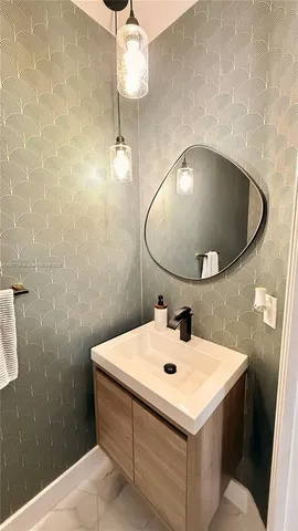 a bathroom with a sink and mirror