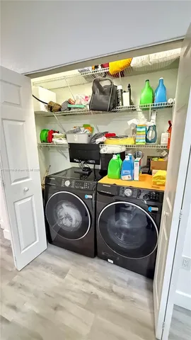 a utility room with sink dryer and washer