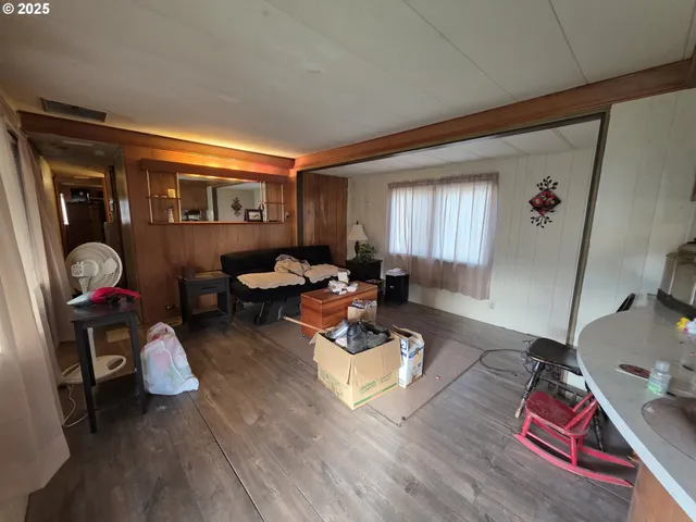 a living room with furniture a rug and a window