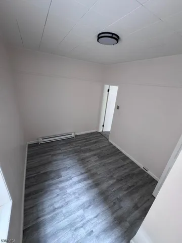 a view of room with wooden floor