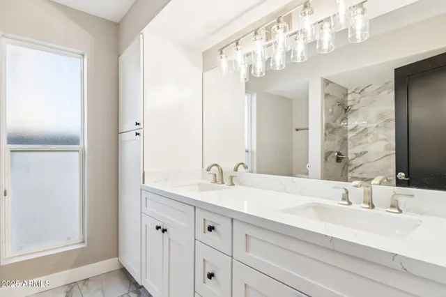 a bathroom with a double vanity sink and a mirror