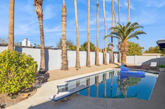 a living room with furniture pool table and chairs