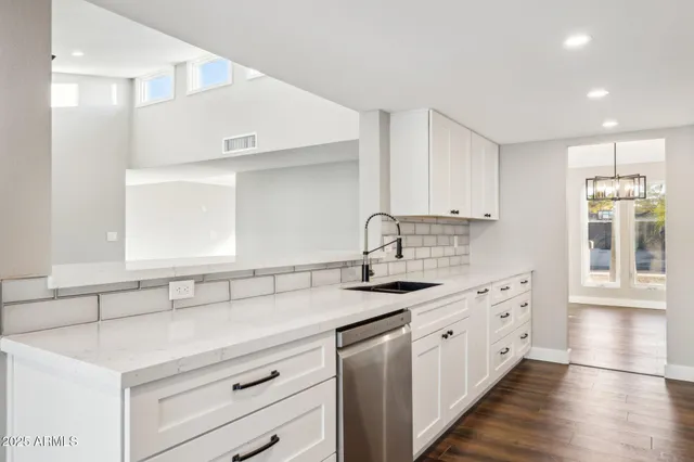 a kitchen with a sink cabinets and window