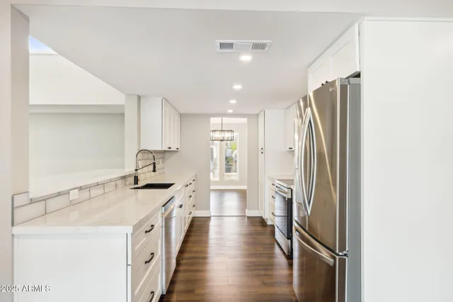 a kitchen with a refrigerator and a sink