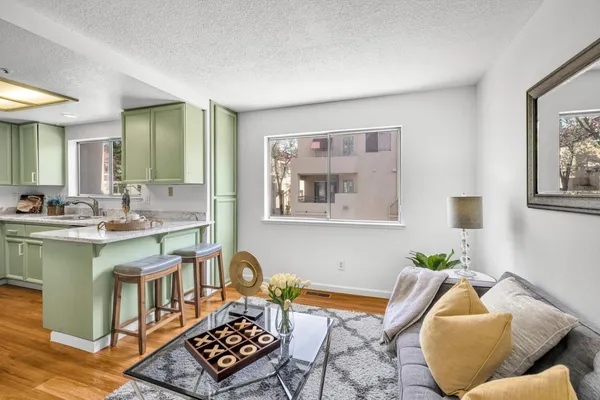 a living room with furniture and a wooden floor